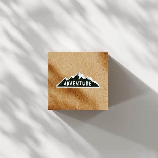 Square brown cardboard box with a Durable vinyl die-cut Adventure Sticker