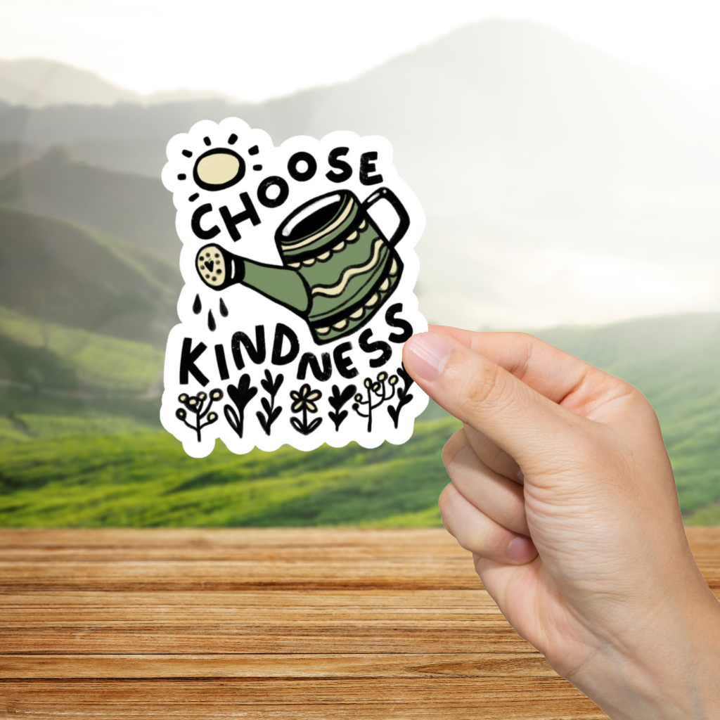 Hand holding a sticker with 'Choose Kindness' text against a scenic background