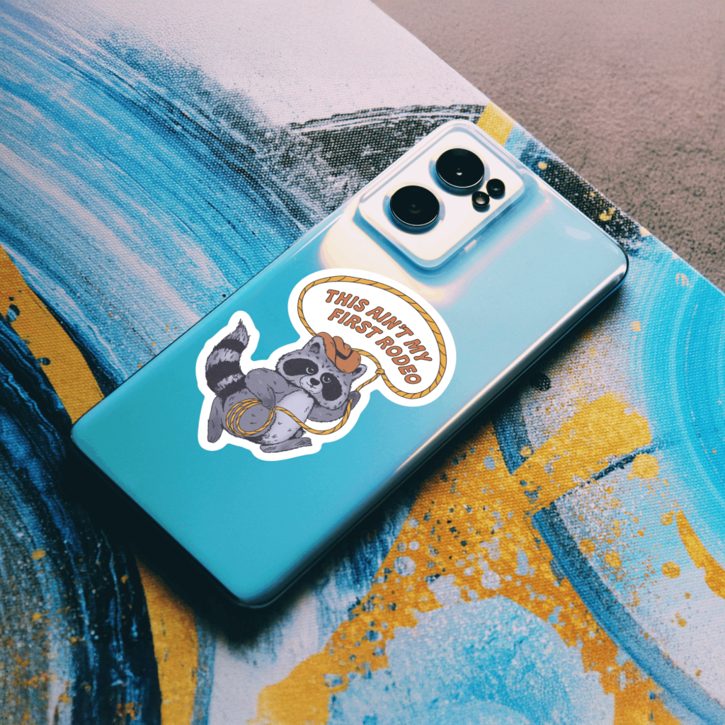 Durable vinyl, die-cut Ain't My First Rodeo Sticker with a racoon.