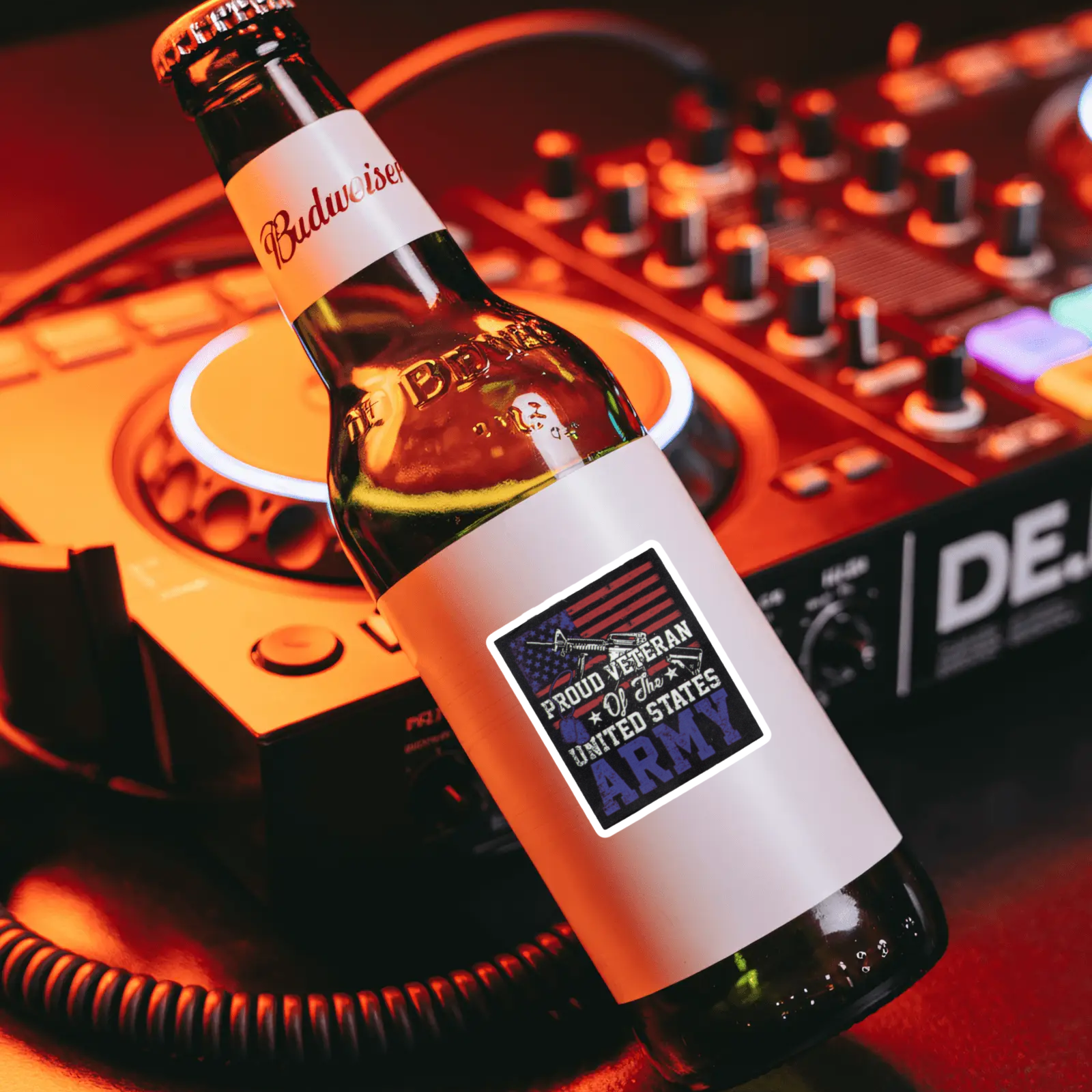 Budweiser beer bottle with a label on a DJ mixer