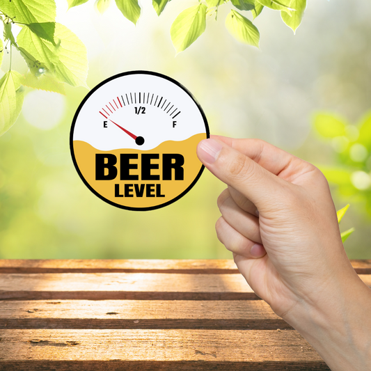 Hand holding a 'Beer Level' gauge against a blurred green outdoor background