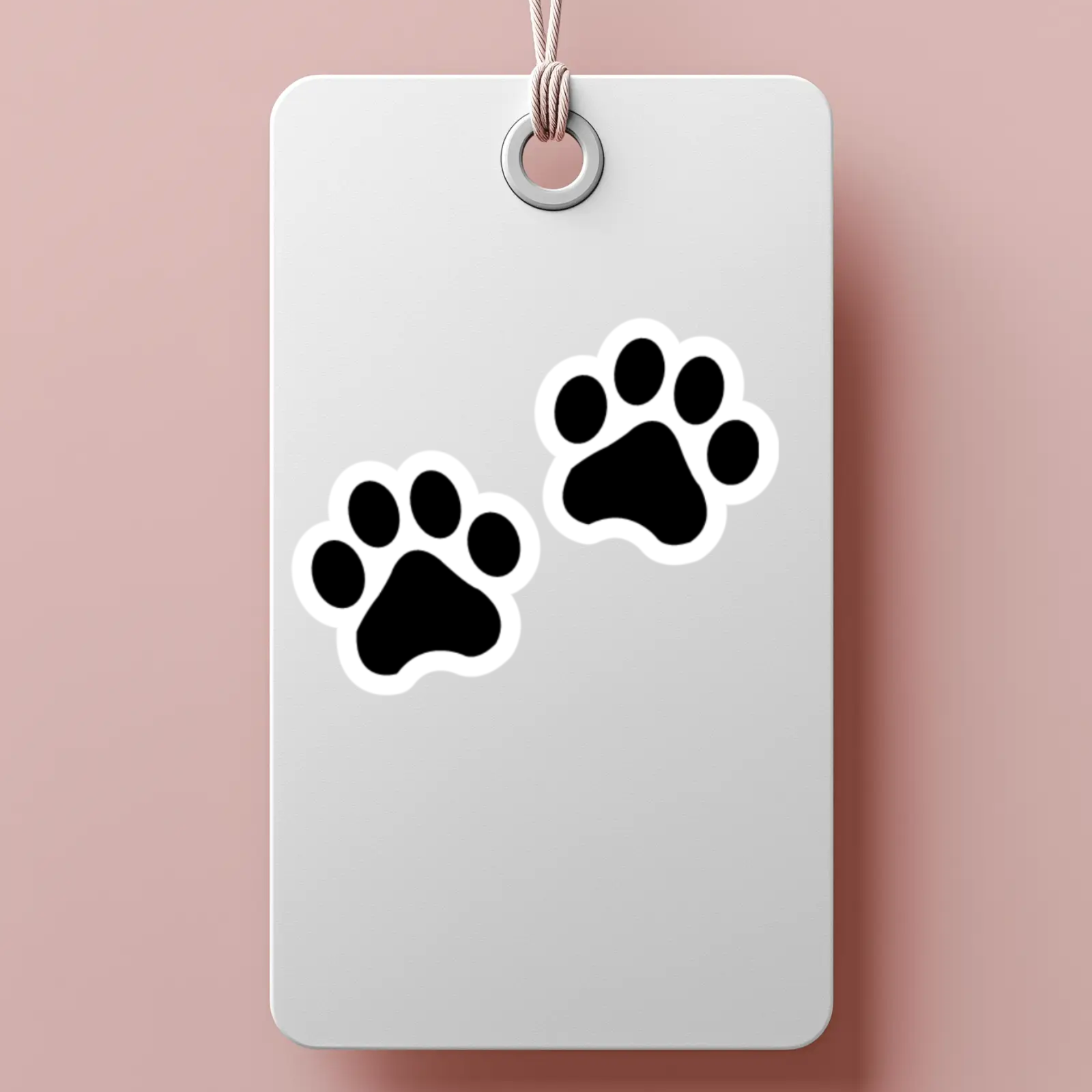 White tag with black paw prints on a pink background