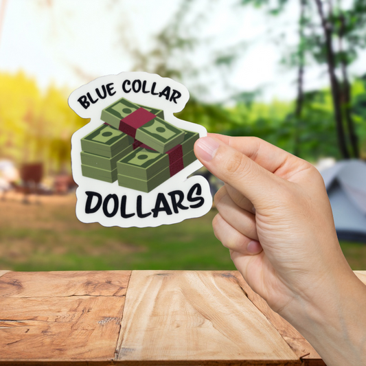 Hand holding a sticker with 'Blue Collar Dollars' text and money design outdoors.