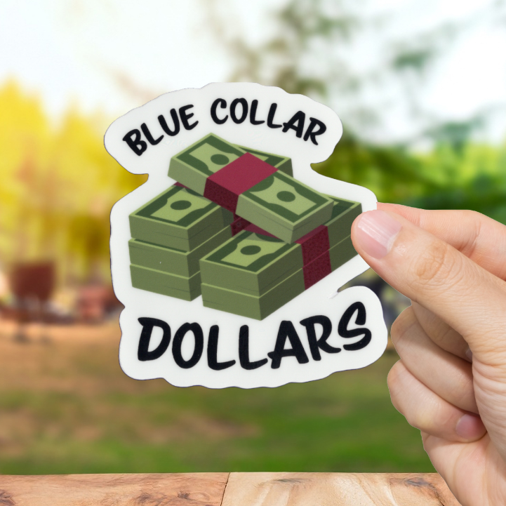 Hand holding a sticker with 'Blue Collar Dollars' text and money design outdoors.