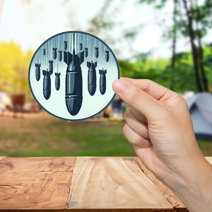 Hand holding a circular object with black bullet-like shapes against a blurred outdoor background