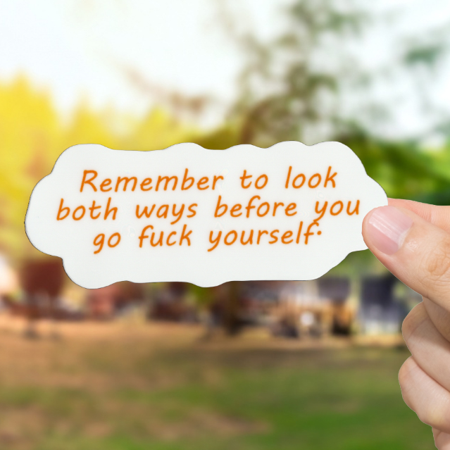 Hand holding a card with text outdoors