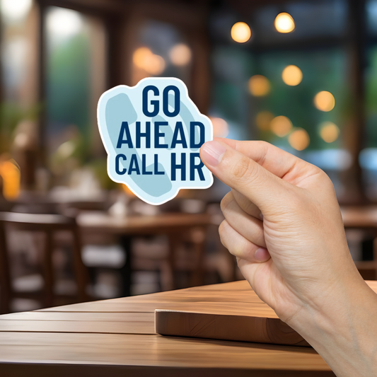 Hand holding a 'GO AHEAD CALL HR' sticker in a blurred restaurant setting