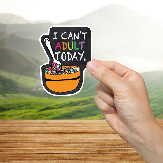 Hand holding a colorful sticker with text 'I Can't Adult Today' against a scenic background