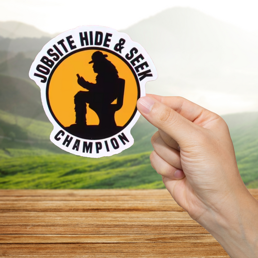 Sticker with 'Jobsite Hide & Seek Champion' design held by a hand against a blurred natural background