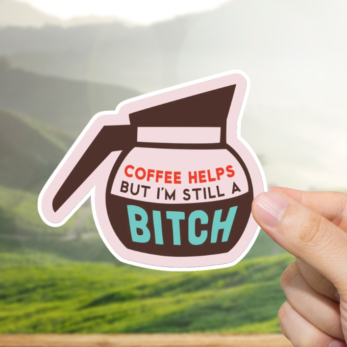 Sticker with coffee pot design and text "Coffee helps but I'm still a bitch." held by a hand against a scenic background