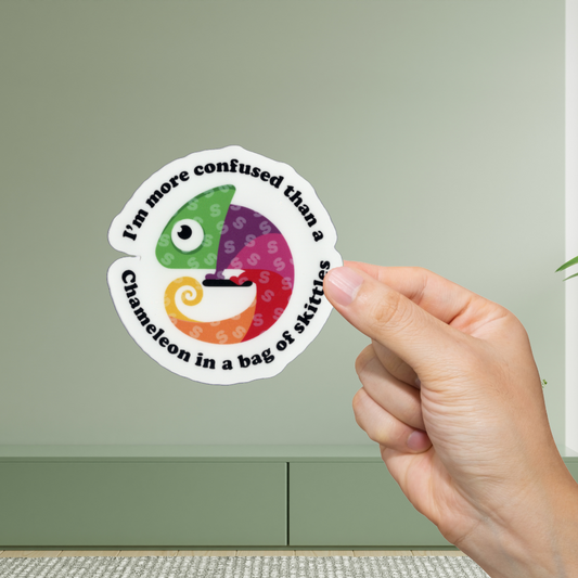 Hand holding a round sticker with a colorful chameleon design and text on a light green background