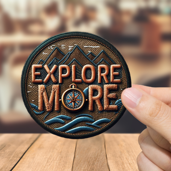 Hand holding a 'Explore More' patch over a blurred bar background