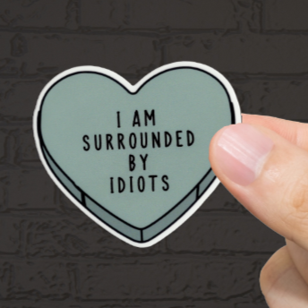 Durable, vinyl, die-cut, Surrounded By Idiots Sticker.
